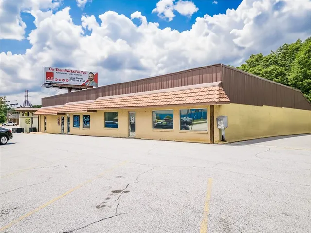 a front view of multi story residential apartment building with grey walls