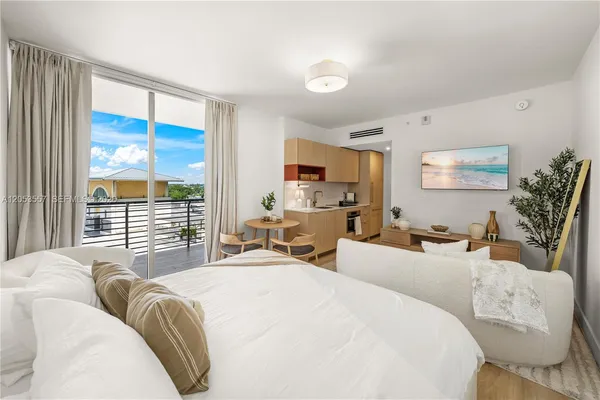 a bedroom with furniture and a large window
