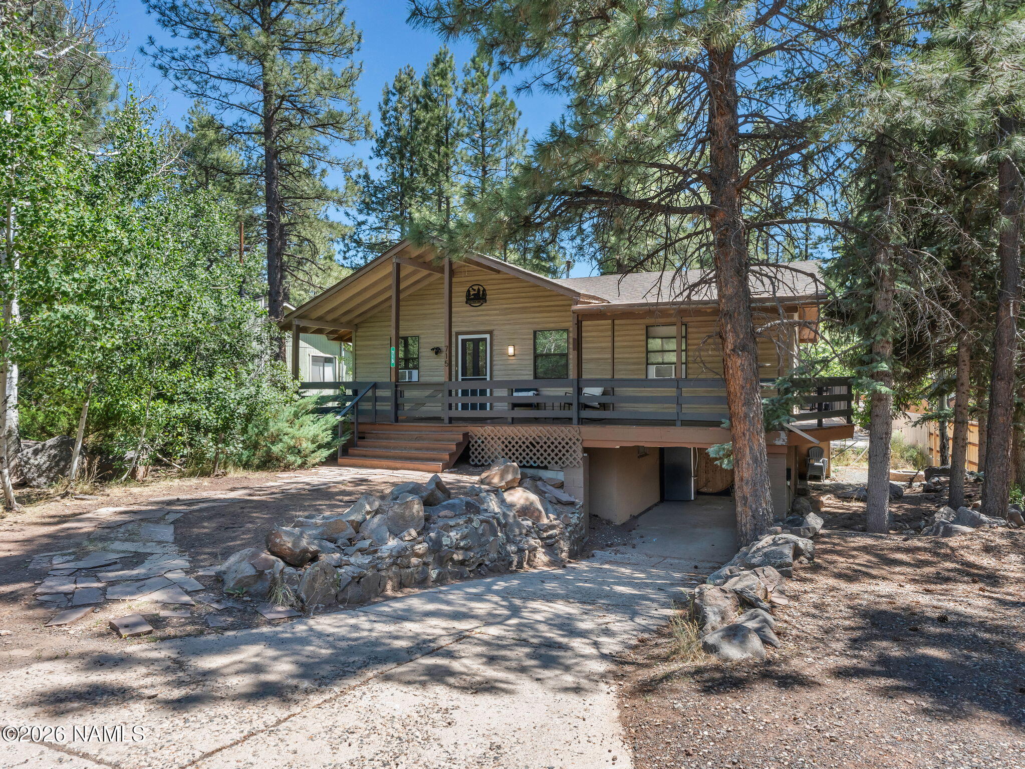 715 Trout Creek Road Munds Park, AZ 86017 - Photo 2 of 46 a view of a house with a yard and large tree
