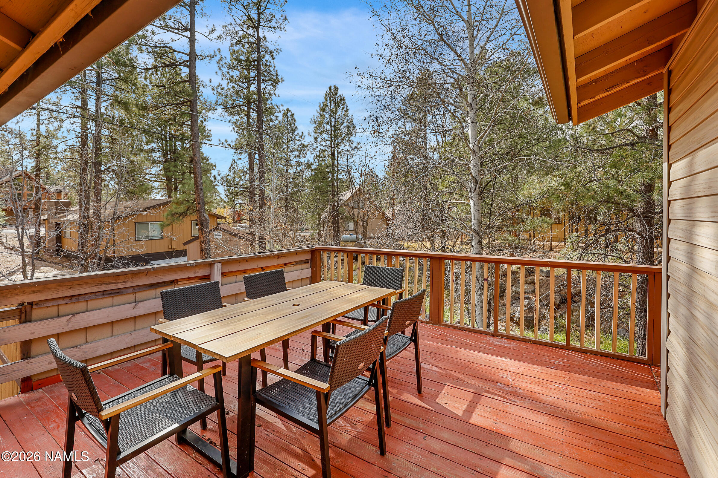 715 Trout Creek Road Munds Park, AZ 86017 - Photo 23 of 46 a view of a chairs and table on the deck