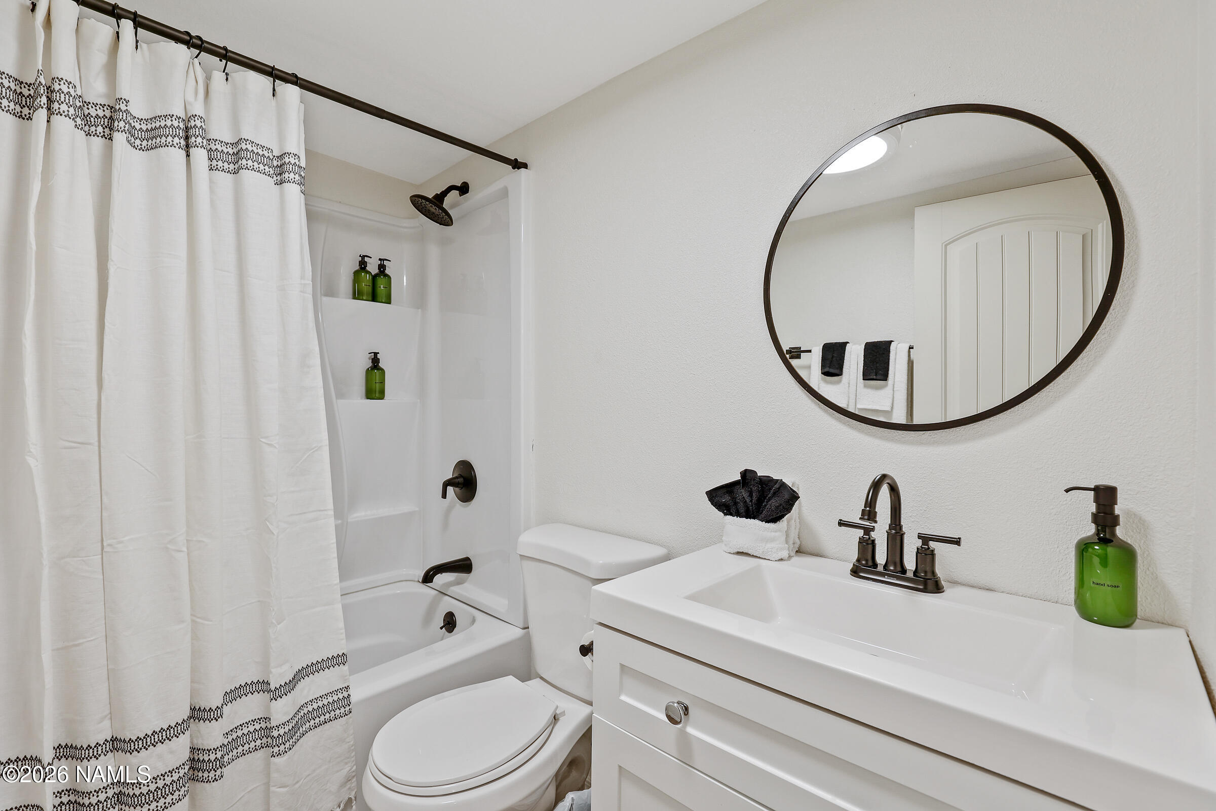 715 Trout Creek Road Munds Park, AZ 86017 - Photo 28 of 46 a bathroom with a sink a mirror a toilet and a mirror