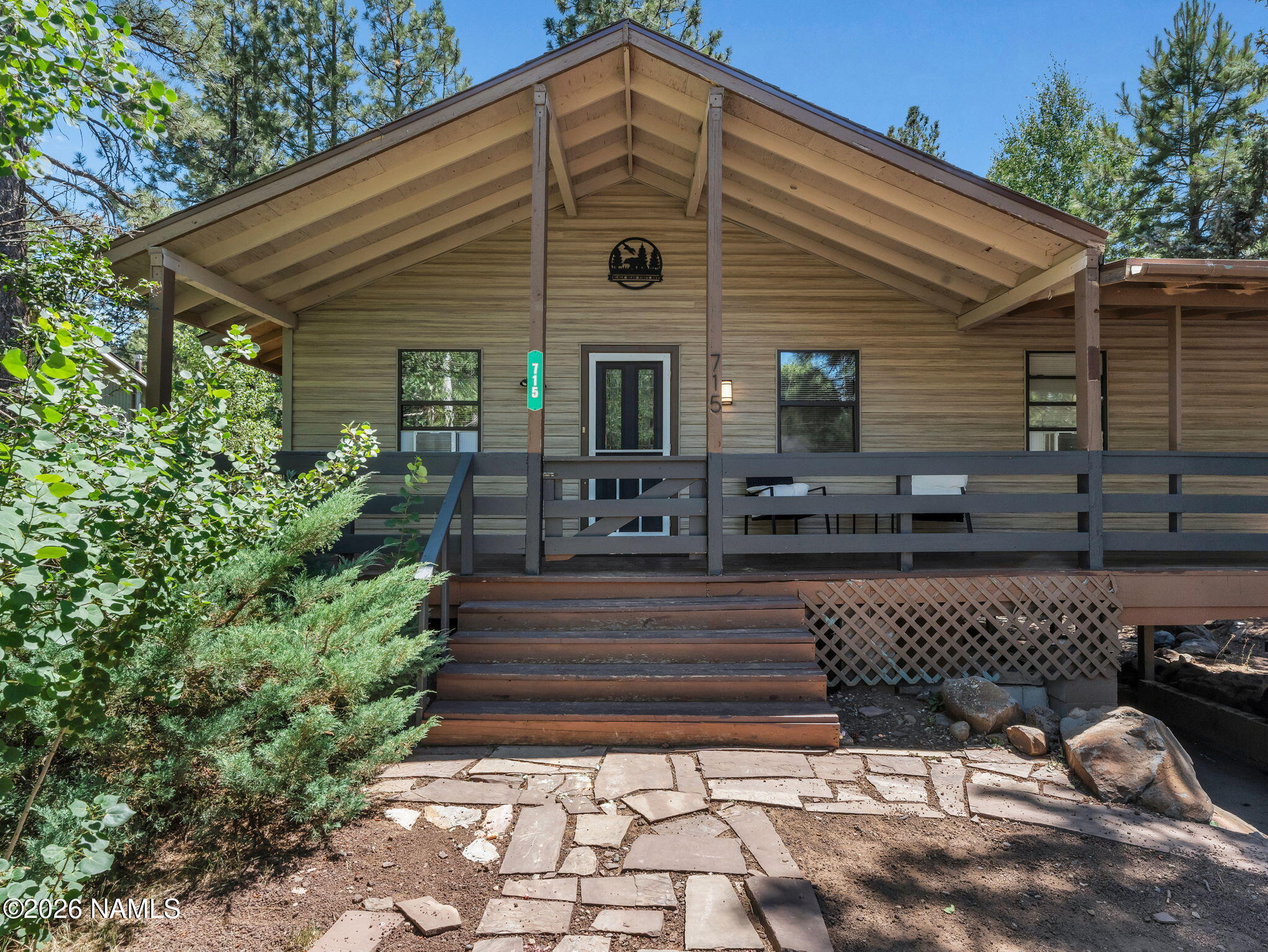 715 Trout Creek Road Munds Park, AZ 86017 - Photo 3 of 46 a front view of a house with garden