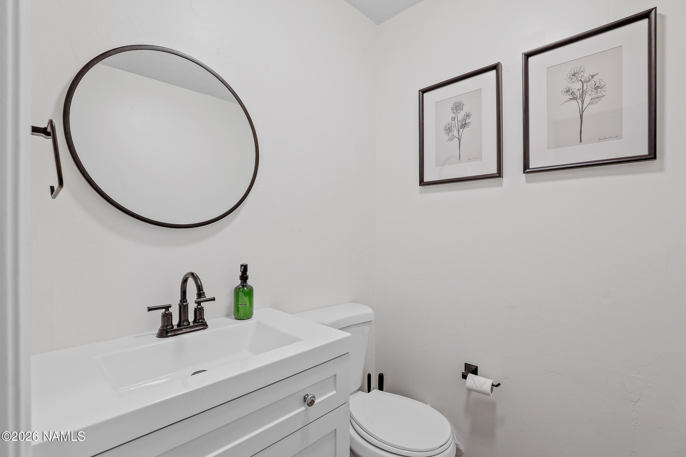 715 Trout Creek Road Munds Park, AZ 86017 - Photo 35 of 46 a bathroom with a sink mirror and toilet