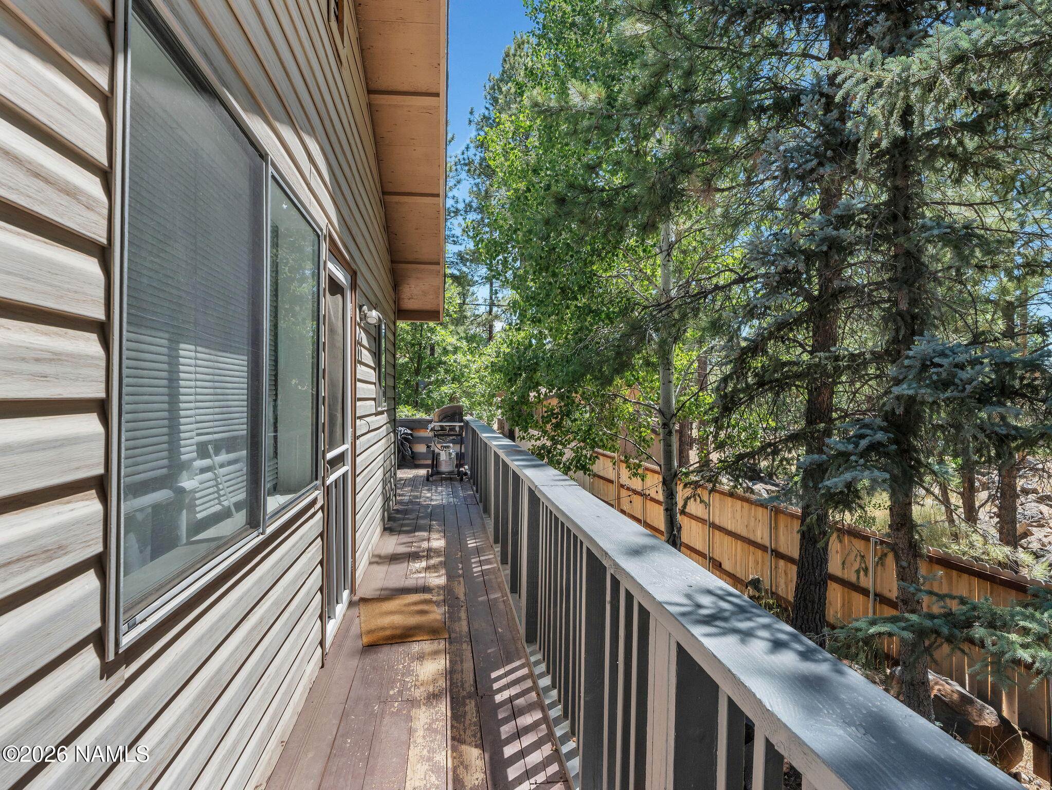 715 Trout Creek Road Munds Park, AZ 86017 - Photo 38 of 46 a view of balcony with wooden floor and fence and a large tree