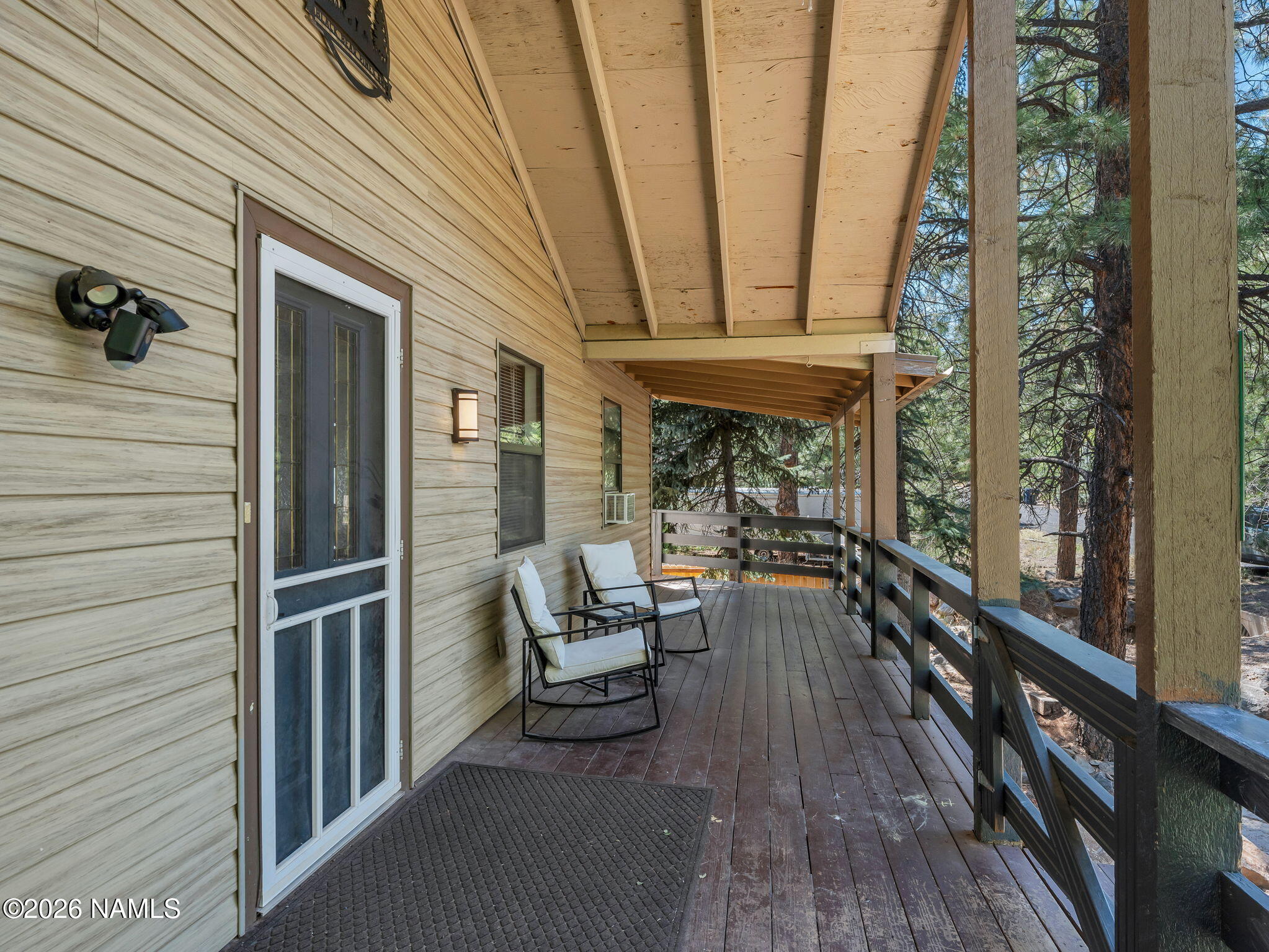 715 Trout Creek Road Munds Park, AZ 86017 - Photo 39 of 46 a view of a balcony with chairs and wooden floor