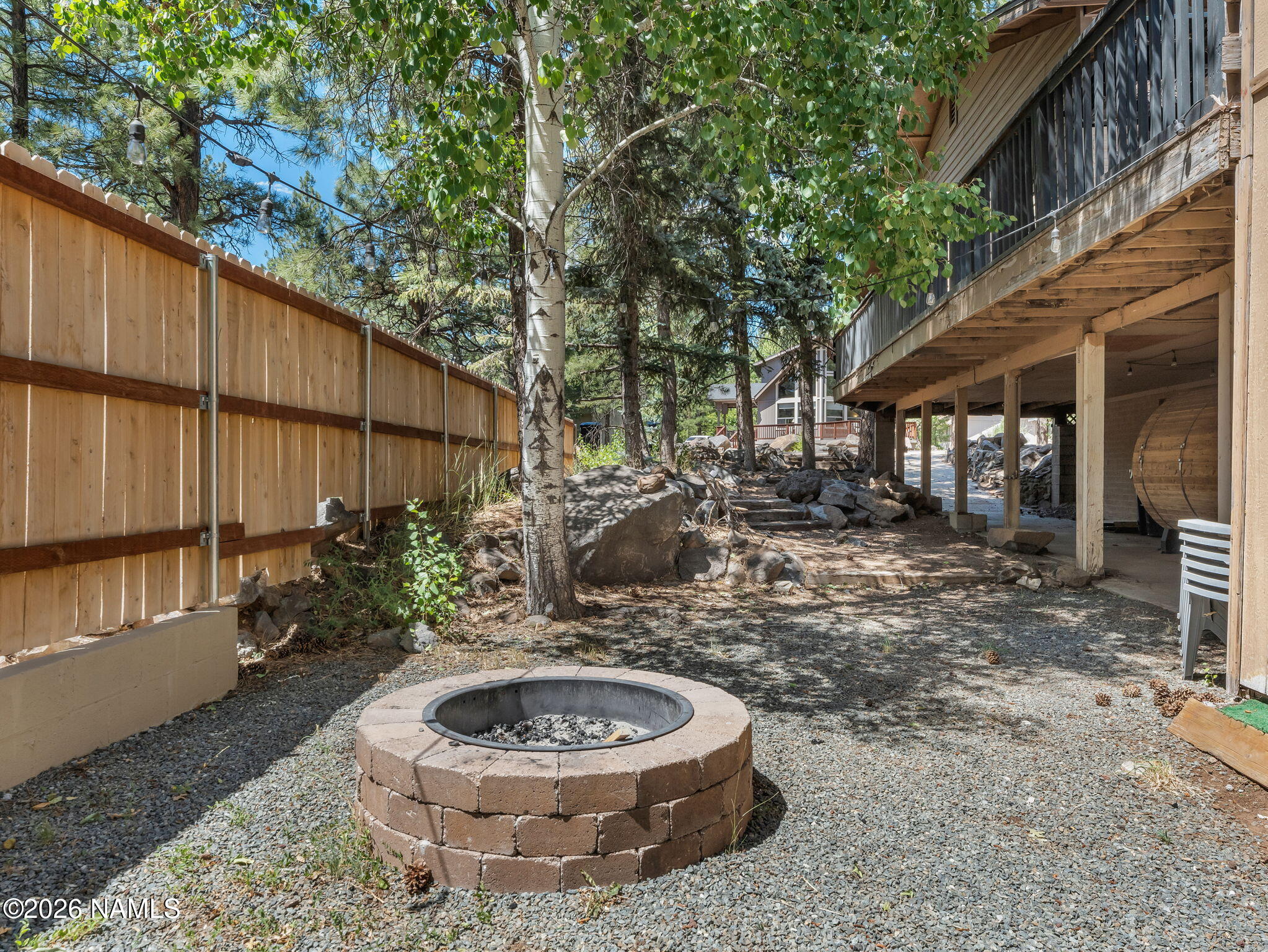 715 Trout Creek Road Munds Park, AZ 86017 - Photo 45 of 46 a backyard of a house with fountain and barbeque oven