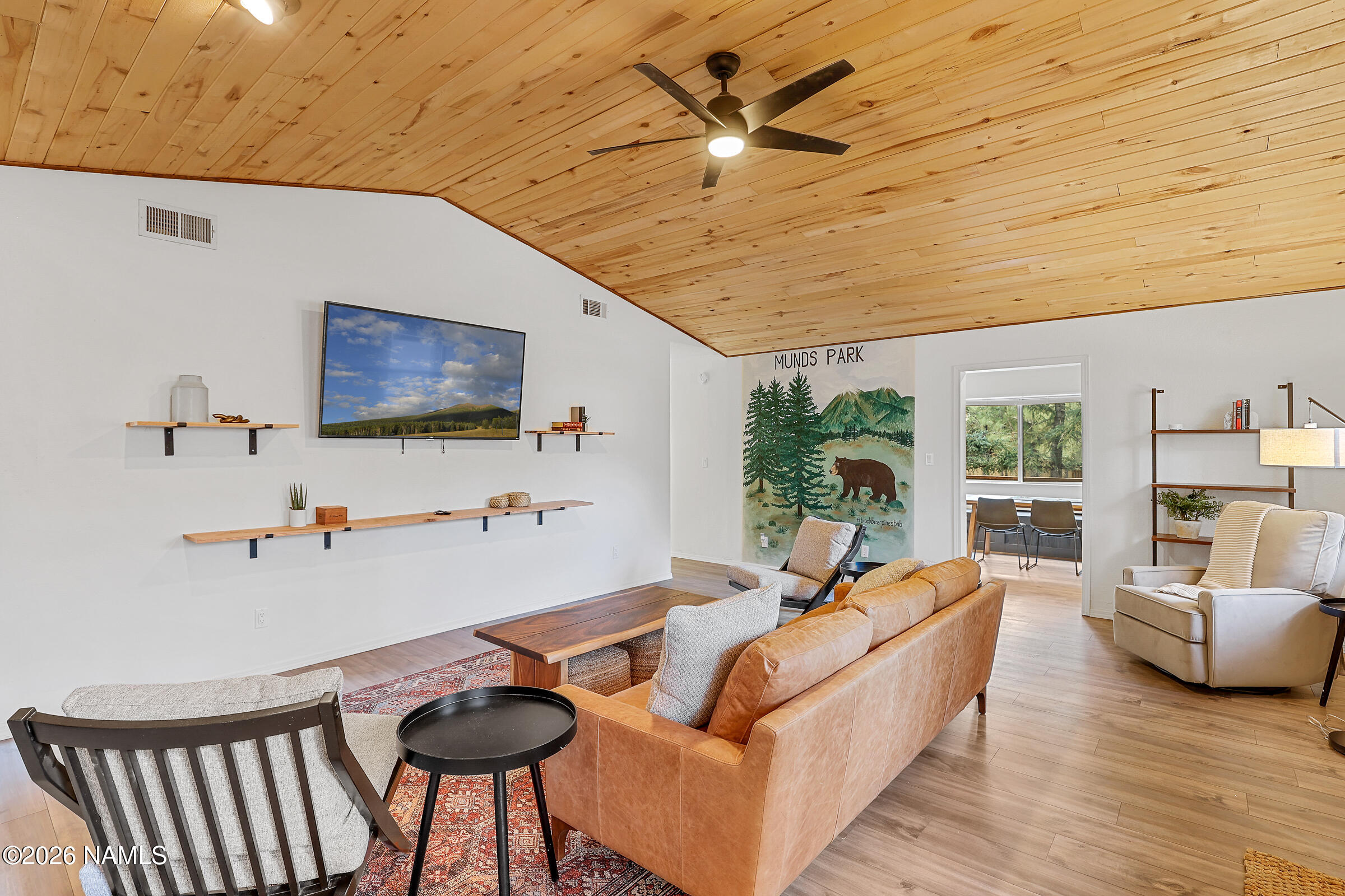 715 Trout Creek Road Munds Park, AZ 86017 - Photo 5 of 46 a living room with furniture and a flat screen tv