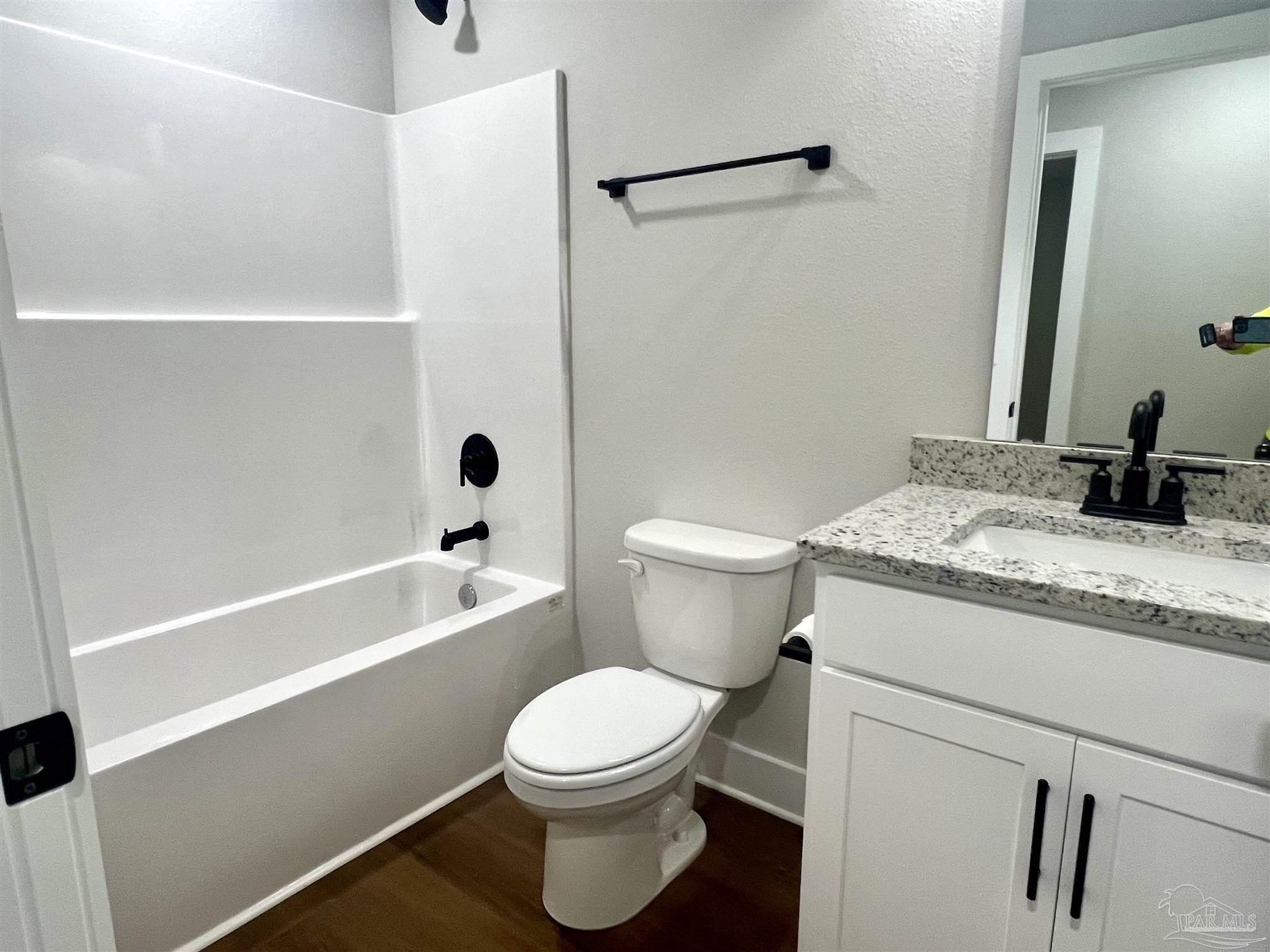 4417 Oak Lane Milton, FL 32583 - Photo 12 of 24 a bathroom with a granite countertop sink toilet and shower
