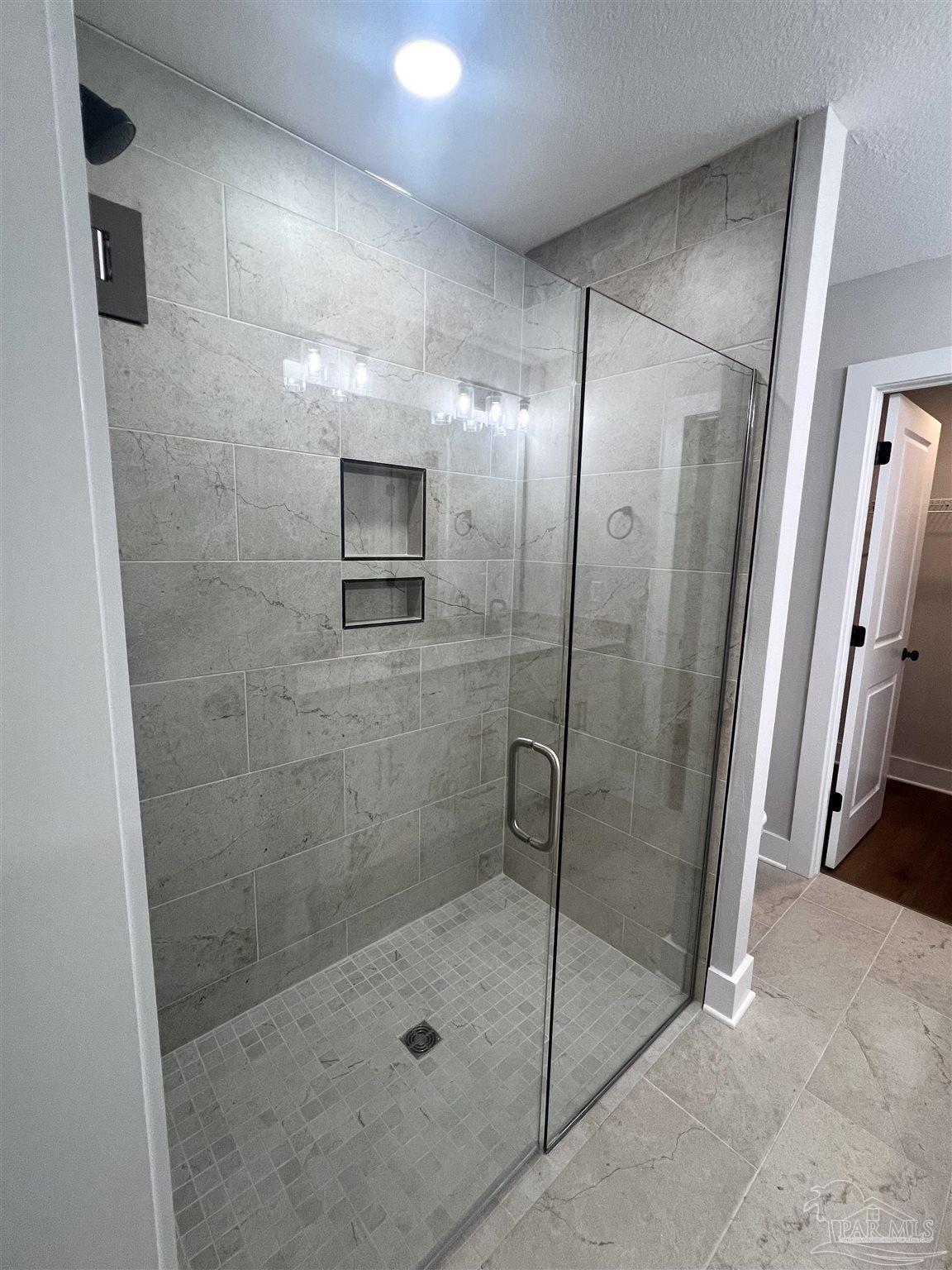 4417 Oak Lane Milton, FL 32583 - Photo 16 of 24 a bathroom with a glass shower door