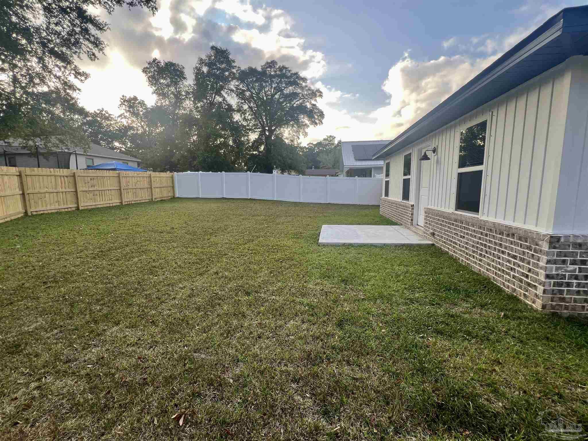 4417 Oak Lane Milton, FL 32583 - Photo 19 of 24 a view of a backyard with a garden