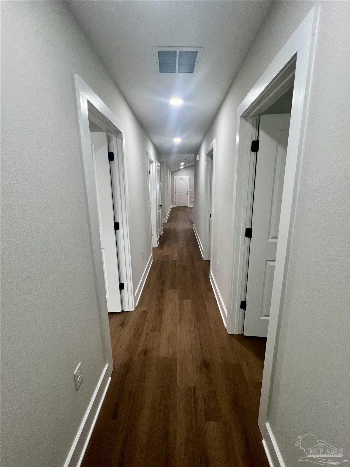 4417 Oak Lane Milton, FL 32583 - Photo 22 of 24 a view of a hallway with wooden floor