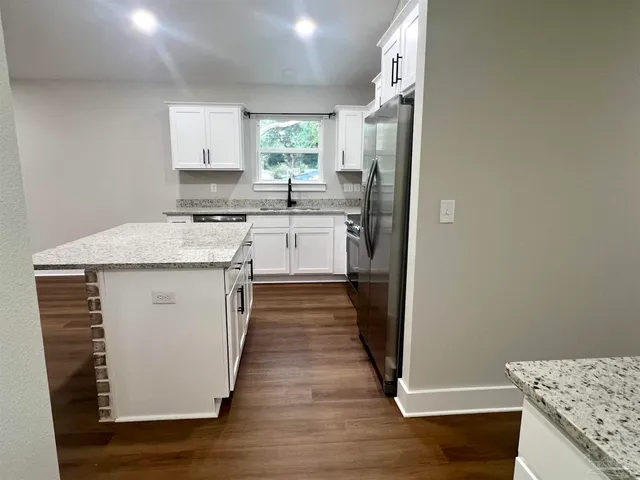 a kitchen with a sink stove and refrigerator
