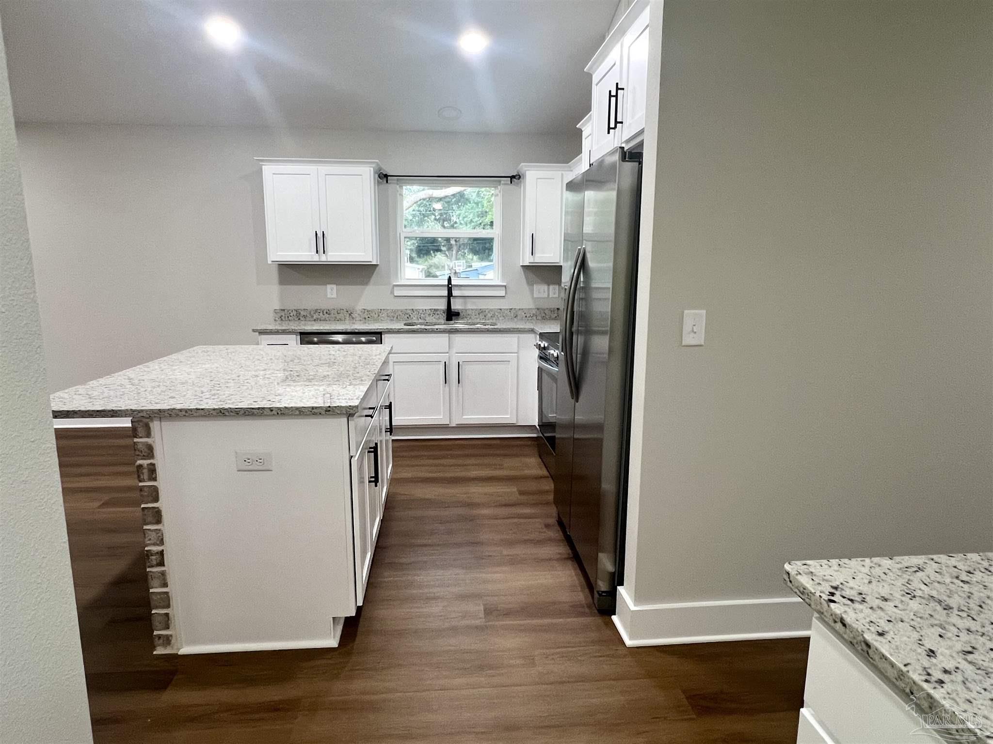 4417 Oak Lane Milton, FL 32583 - Photo 9 of 24 a kitchen with a sink stove and refrigerator