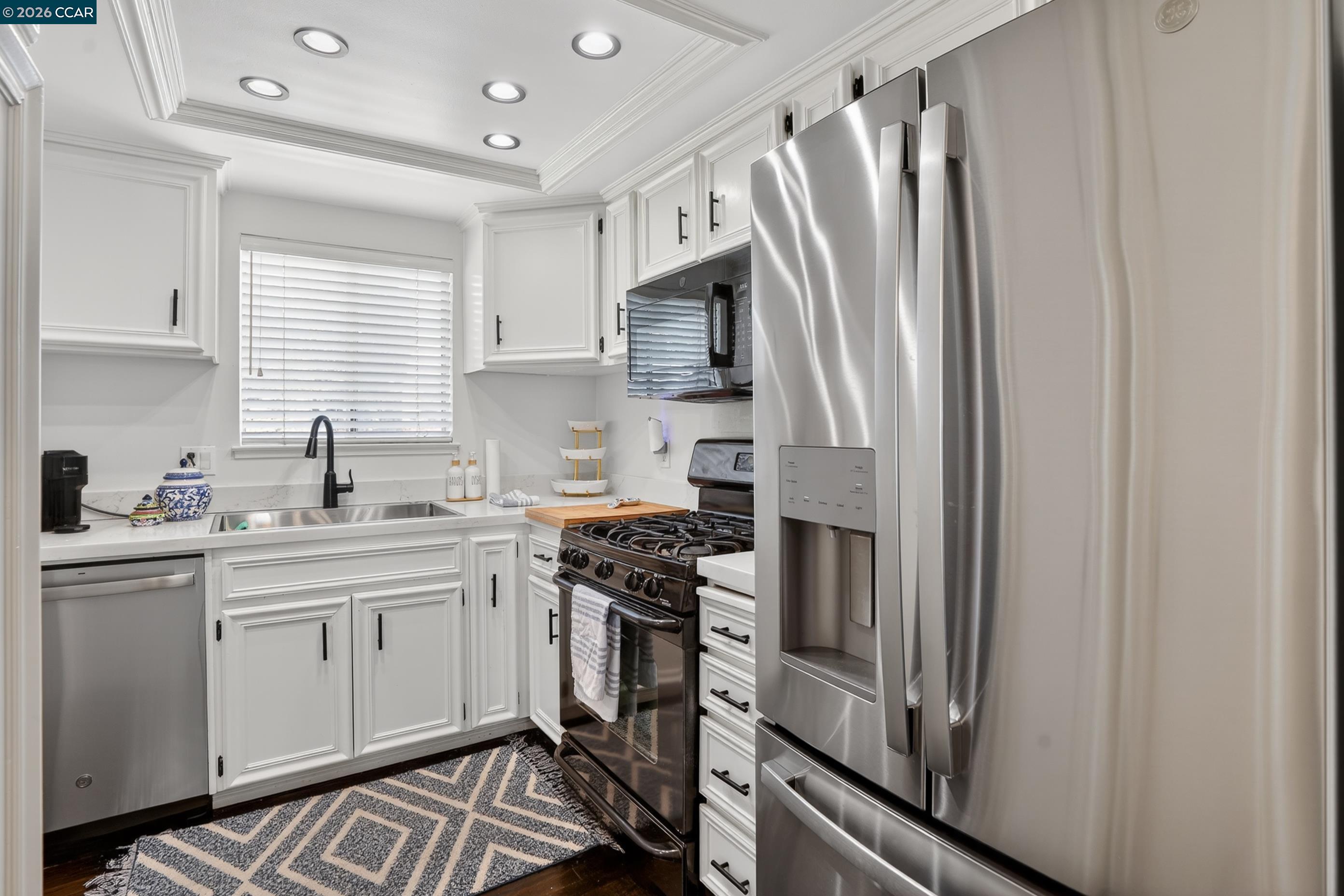 1812 Wildbrook Court, Unit C Concord, CA 94521 - Photo 15 of 35 a kitchen with stainless steel appliances a refrigerator sink and white cabinets