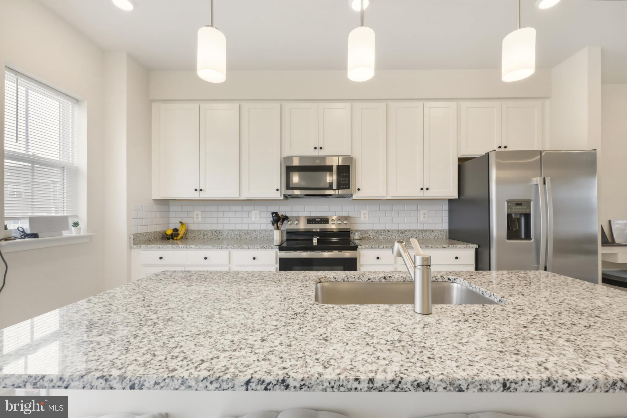 51 Short Br Drive Ranson, WV 25438 - Photo 14 of 30 Modern kitchen with sleek granite island.