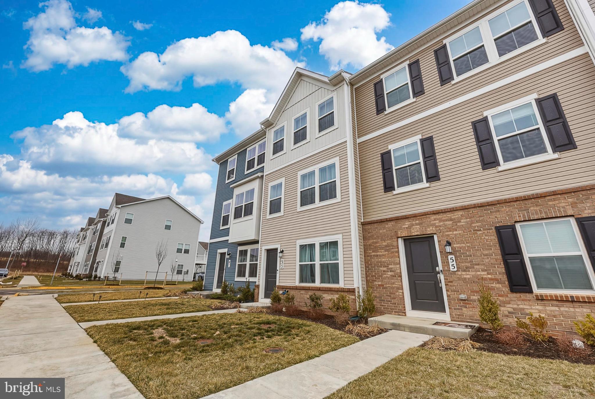 51 Short Br Drive Ranson, WV 25438 - Photo 3 of 30 Charming townhomes under a bright sky.