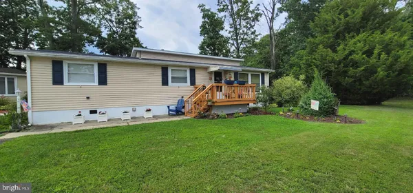 a front view of house with yard and green space