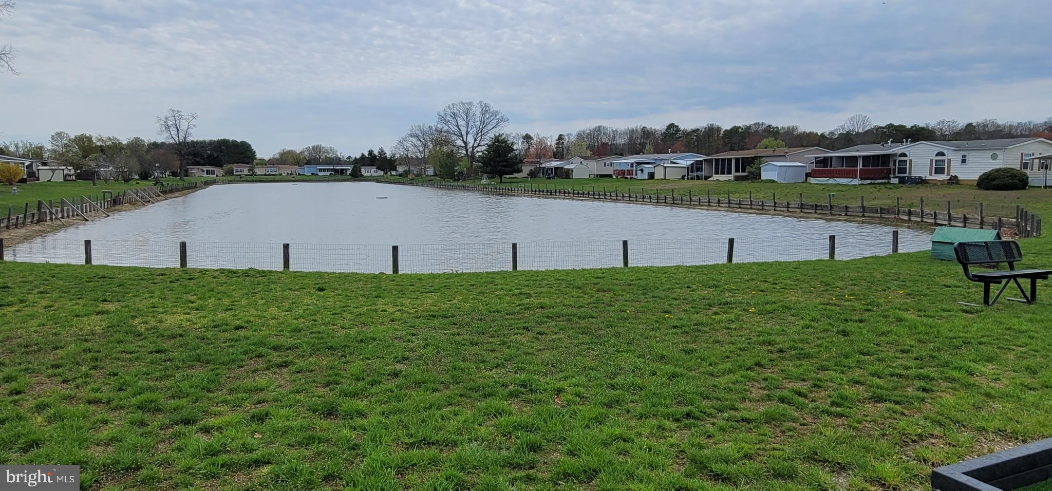 130 Country Lane Buena, NJ 08310 - Photo 33 of 41 a view of a lake with a big yard and large trees