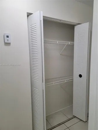 a view of an empty room with a bathroom