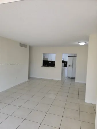a view of a livingroom with an empty space and a fireplace