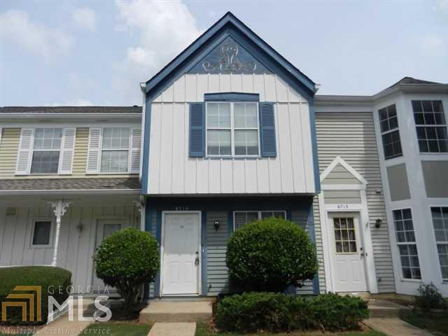 6715 Colchester Place Northwest Norcross, GA 30093 - Photo 1 of 1 a front view of a house with a yard garage and outdoor seating