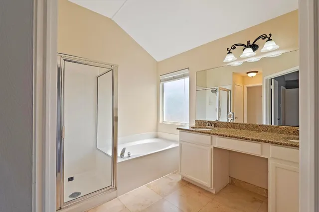a view of an empty room with wooden floor and a ceiling fan