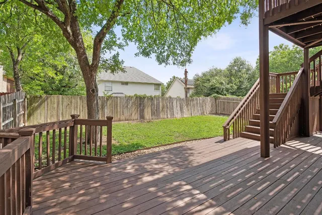 a balcony with wooden floor and fence