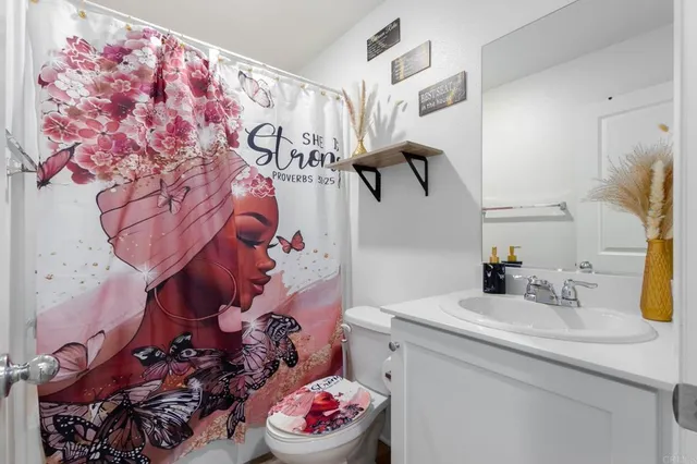 a bathroom with a sink mirror and vanity