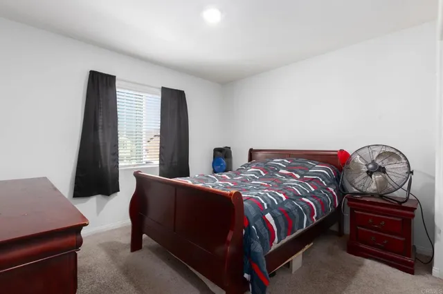 a bedroom with a bed and window