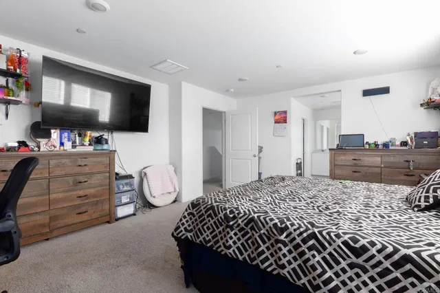 a bedroom with a bed and flat screen tv