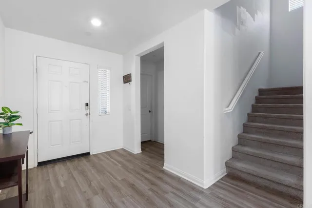 a view of an entryway with wooden floor
