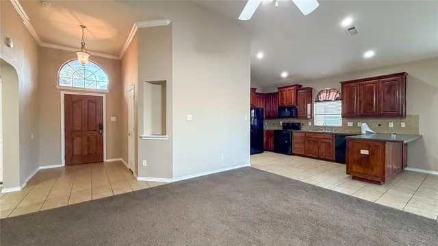 a open kitchen with cabinets and window