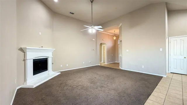 a view of a livingroom with a fireplace and chandelier fan