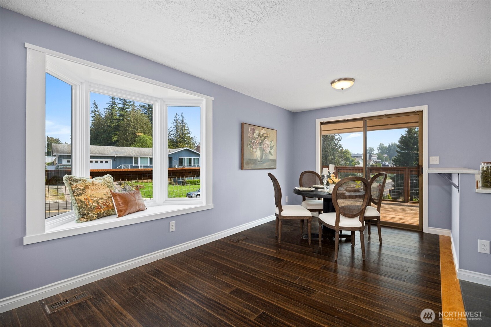 403 17th Street Lynden, WA 98264 - Photo 11 of 40 a dining room with wooden floor a glass table and windows