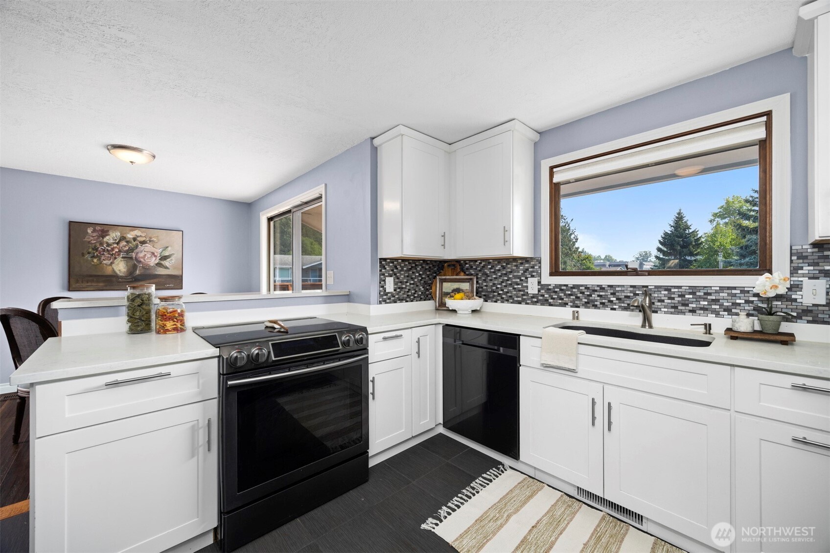403 17th Street Lynden, WA 98264 - Photo 14 of 40 a kitchen with a stove sink and cabinets