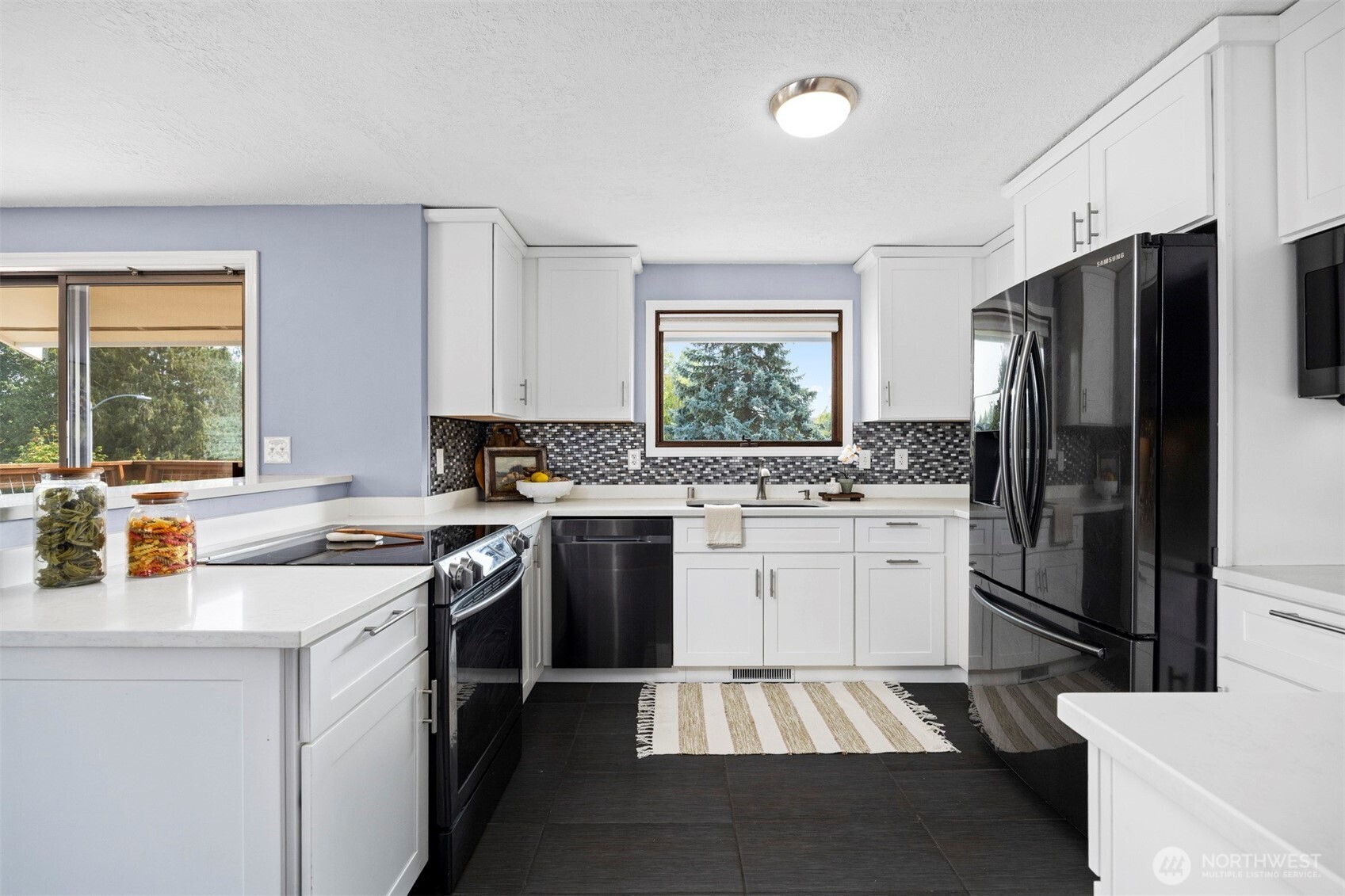403 17th Street Lynden, WA 98264 - Photo 15 of 40 a kitchen with a sink stove and refrigerator
