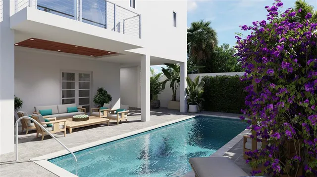 a view of a house with backyard and sitting area