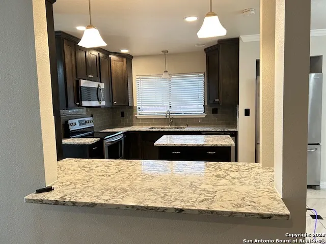 a kitchen with kitchen island granite countertop counter top space a sink and dishwasher