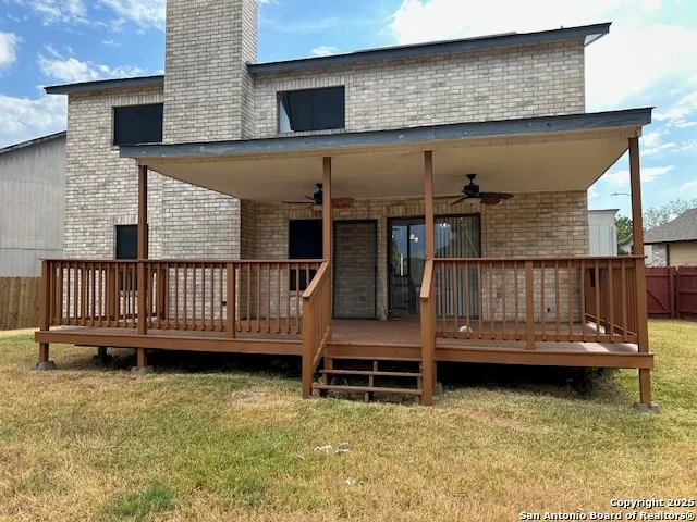a view of a wooden deck with a yard