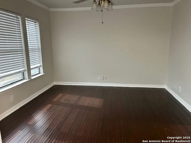a view of a room with wooden floor and window