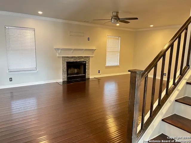 a view of a livingroom with wooden floor and a fireplace