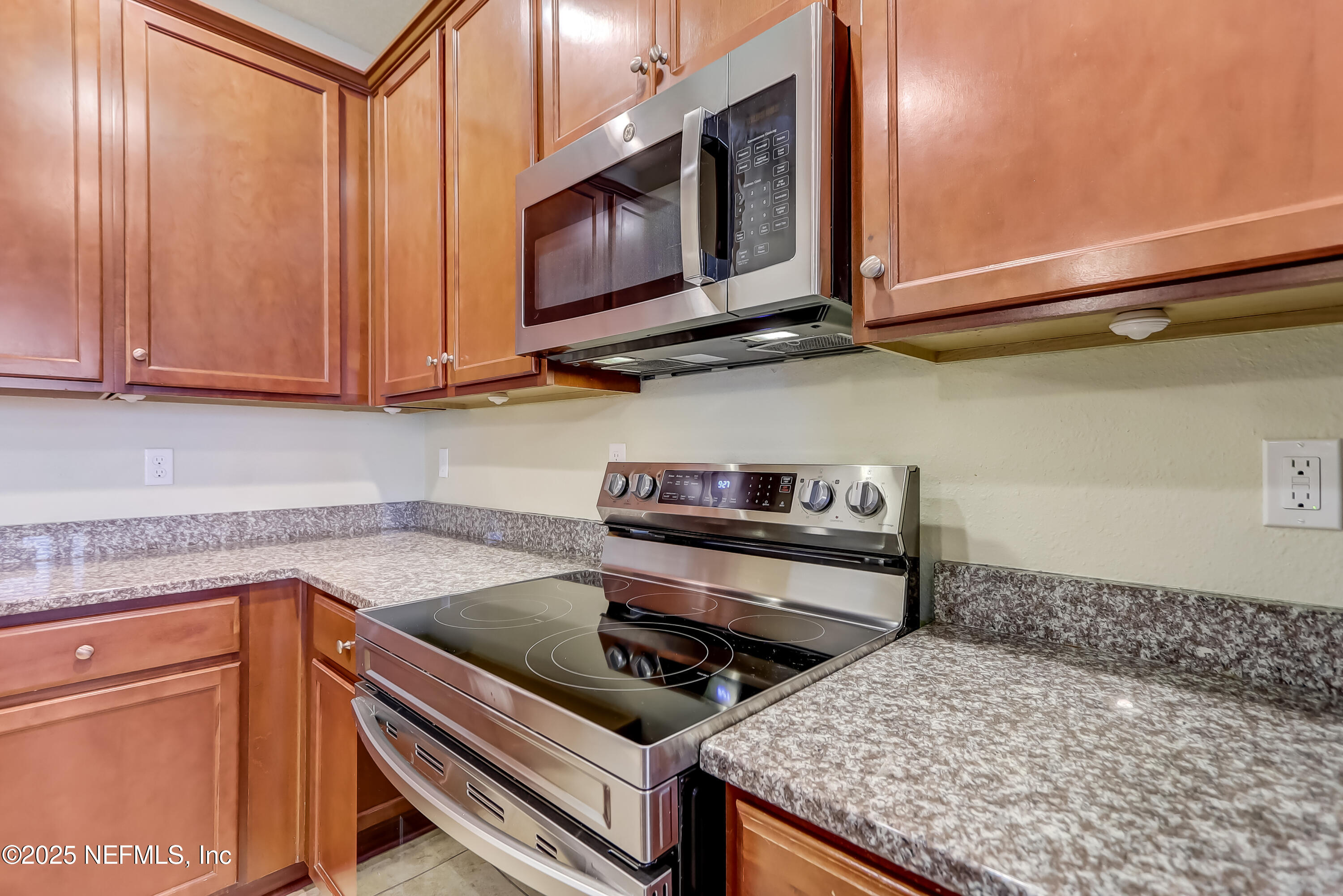 3838 Chasing Falls Road Orange Park, FL 32065 - Photo 11 of 36 a kitchen with a stove and a microwave