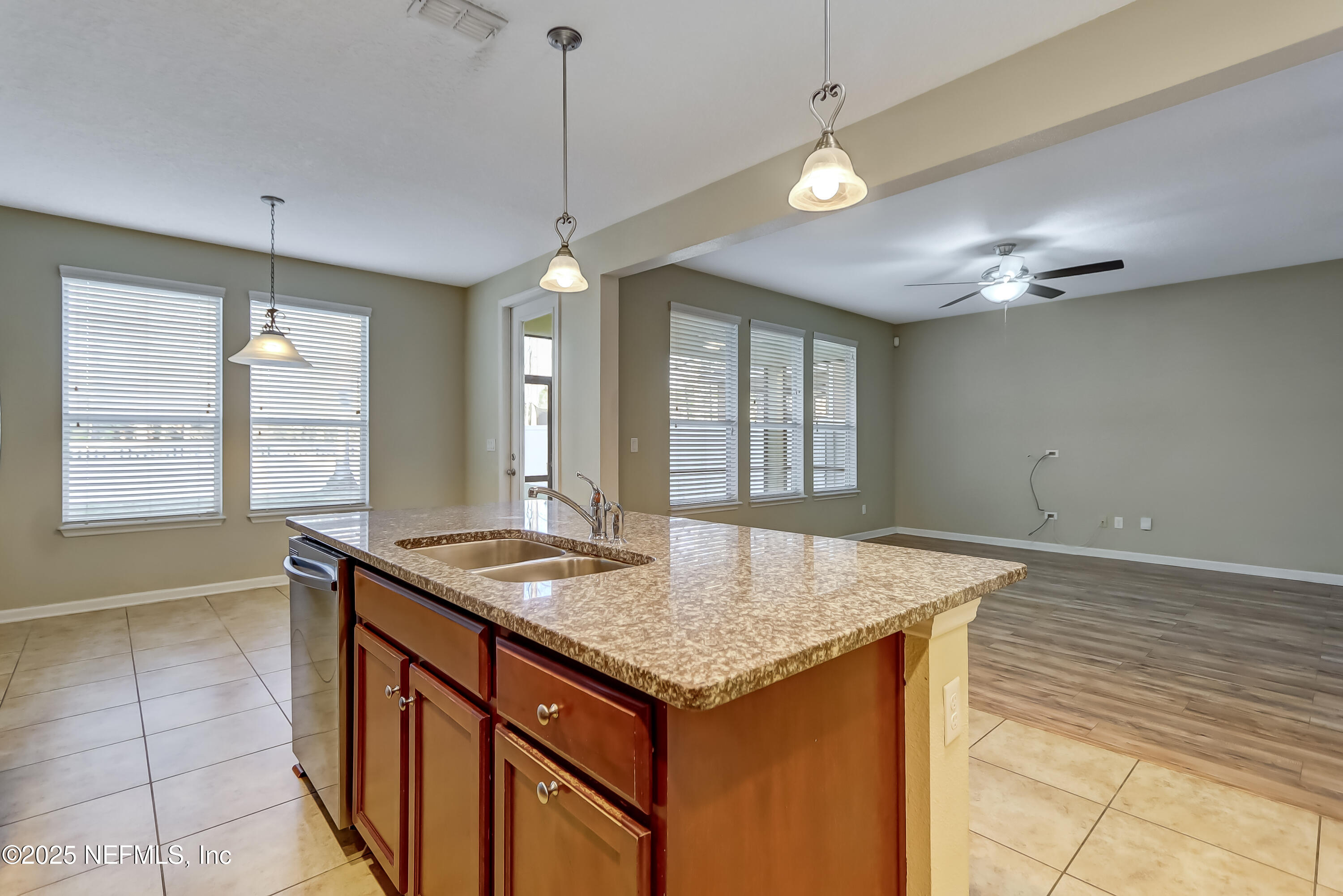 3838 Chasing Falls Road Orange Park, FL 32065 - Photo 12 of 36 a kitchen with granite countertop sink and chandelier