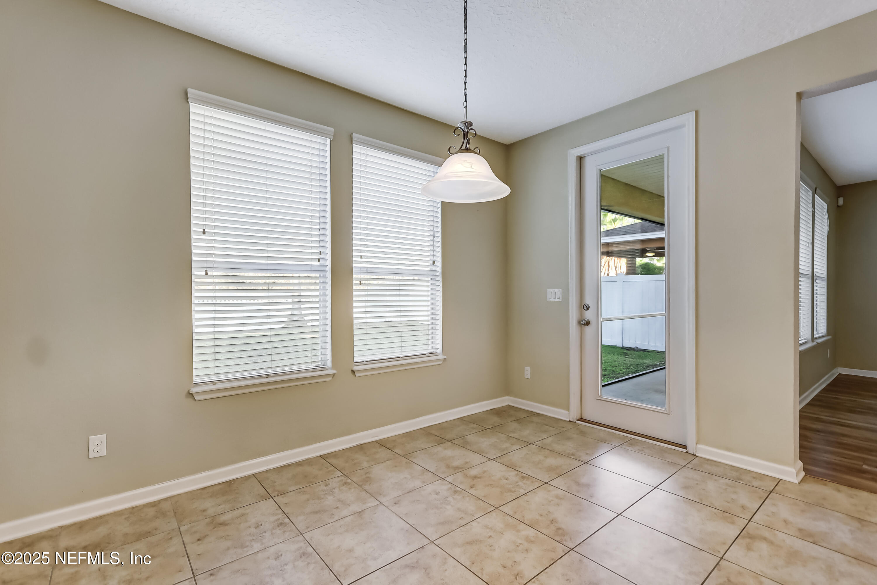 3838 Chasing Falls Road Orange Park, FL 32065 - Photo 13 of 36 an empty room with windows and chandelier
