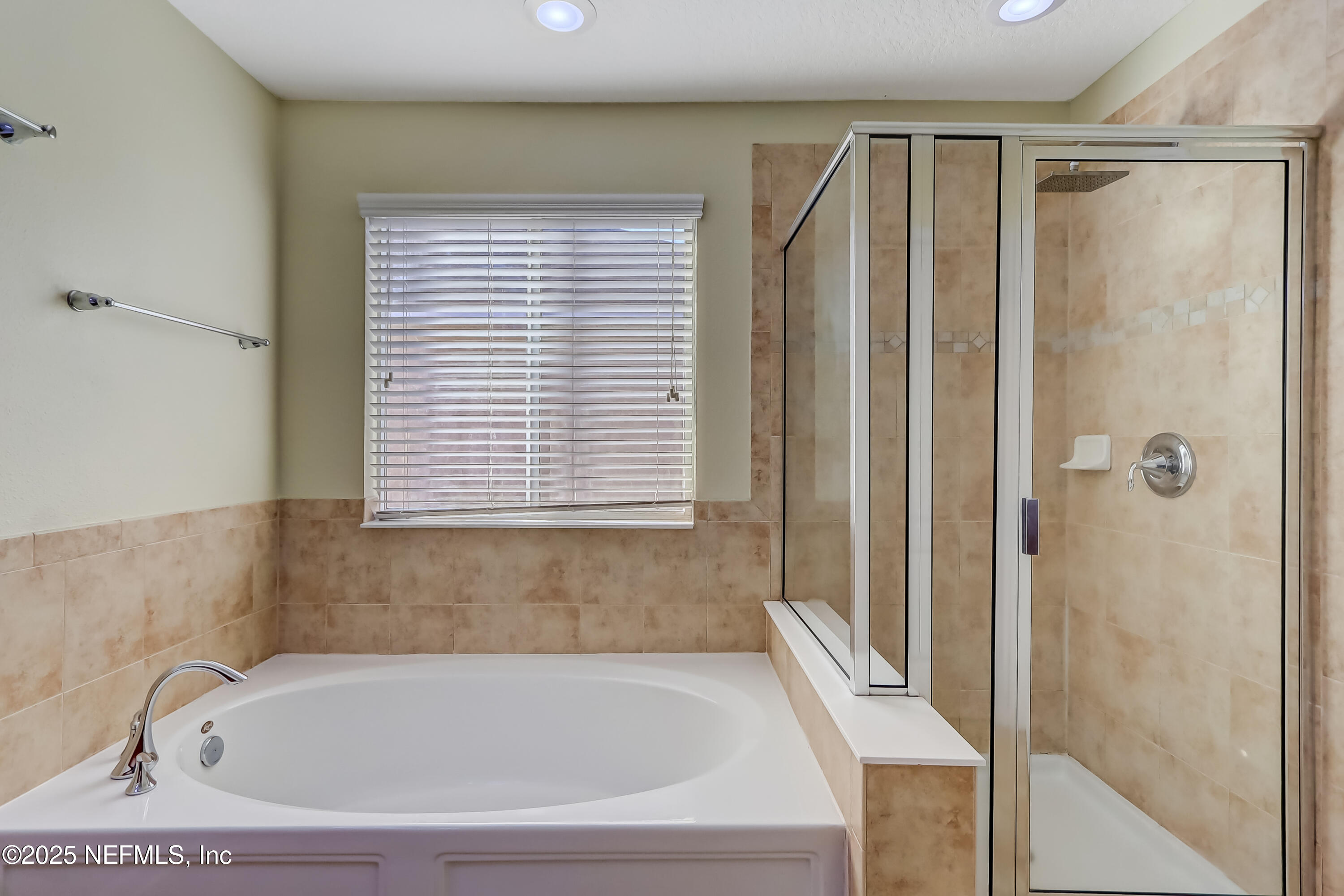 3838 Chasing Falls Road Orange Park, FL 32065 - Photo 23 of 36 a bathroom with a bathtub and a shower