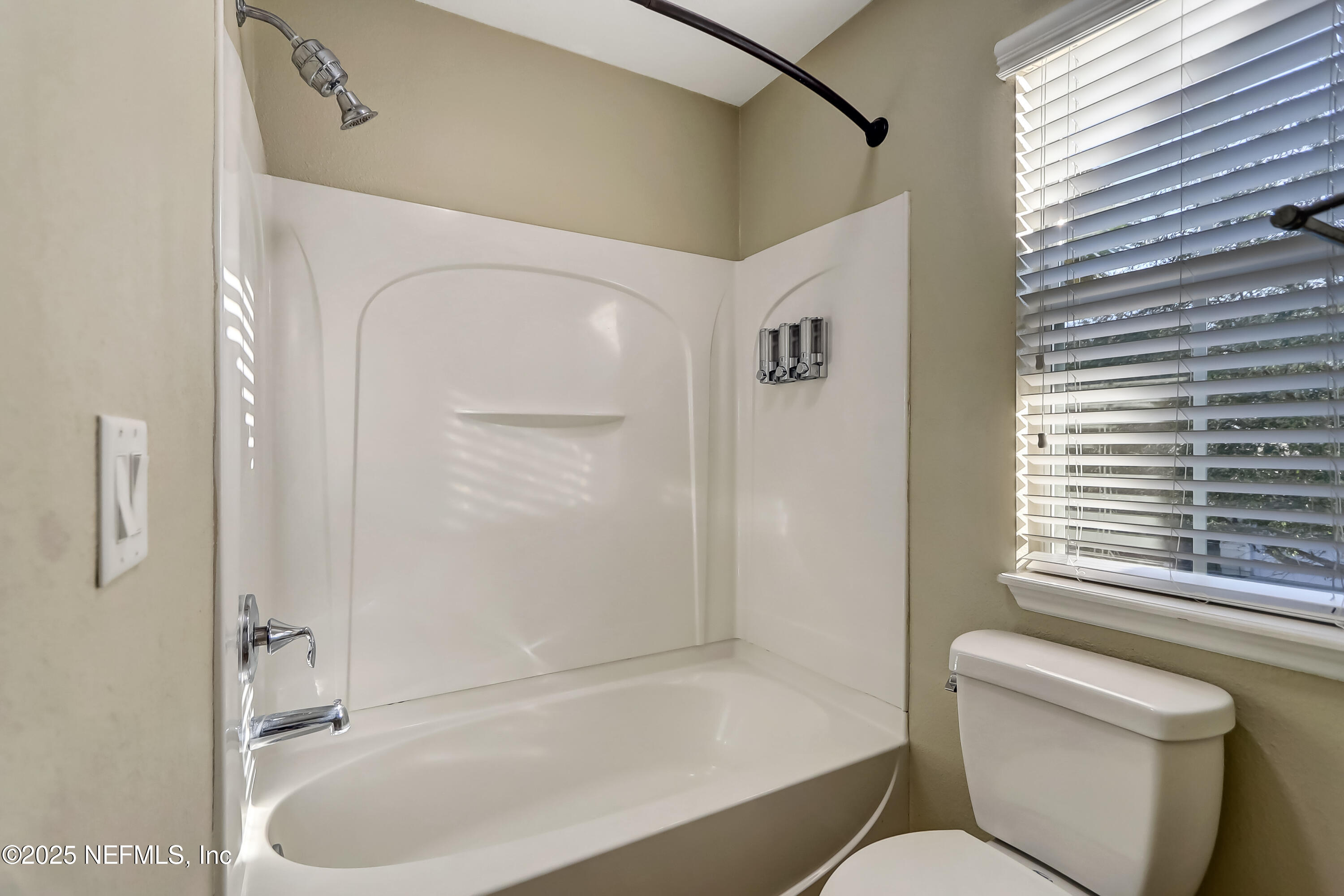 3838 Chasing Falls Road Orange Park, FL 32065 - Photo 29 of 36 a bathroom with a toilet and a bathtub