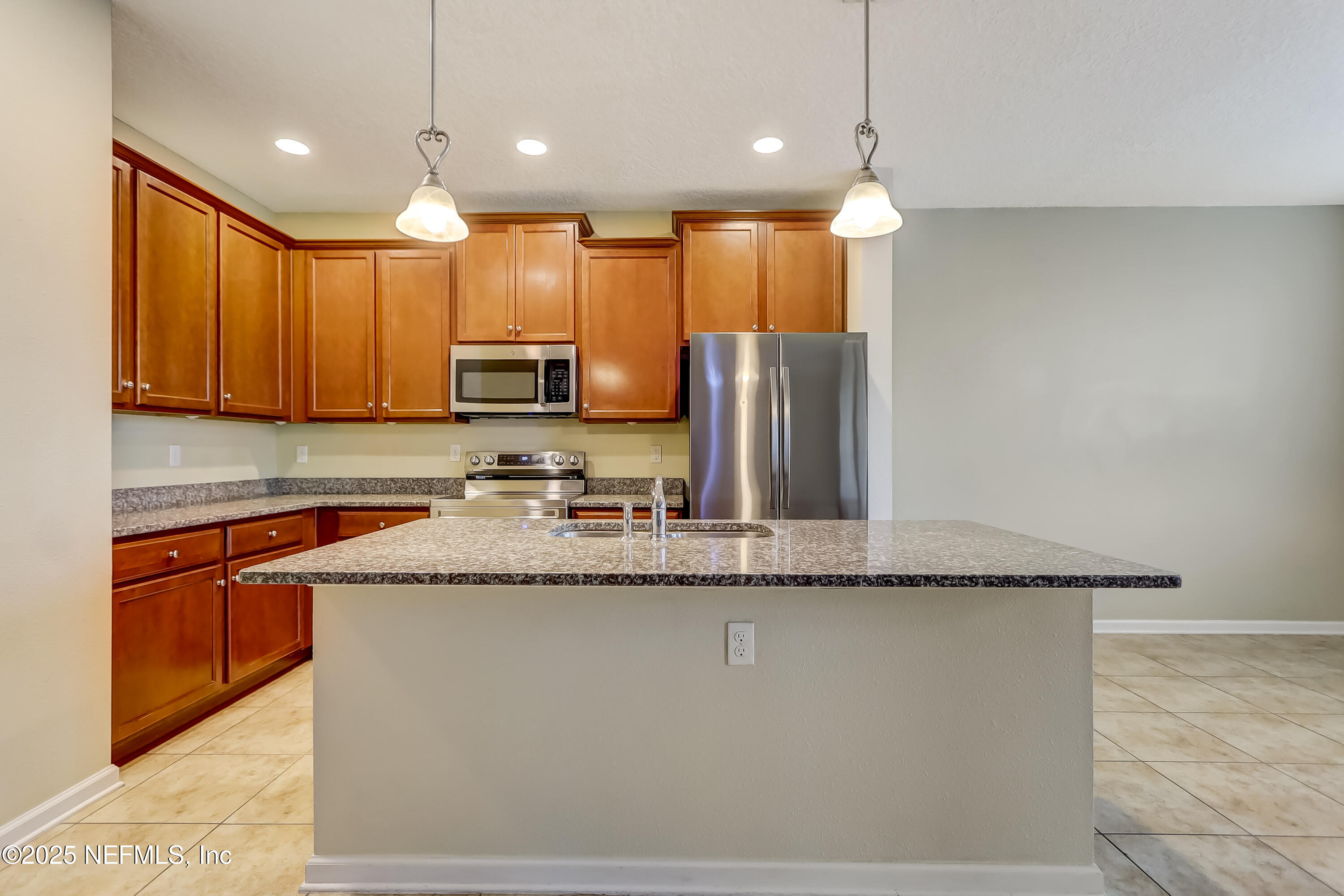 3838 Chasing Falls Road Orange Park, FL 32065 - Photo 8 of 36 a large kitchen with granite countertop a sink a counter space appliances and cabinets