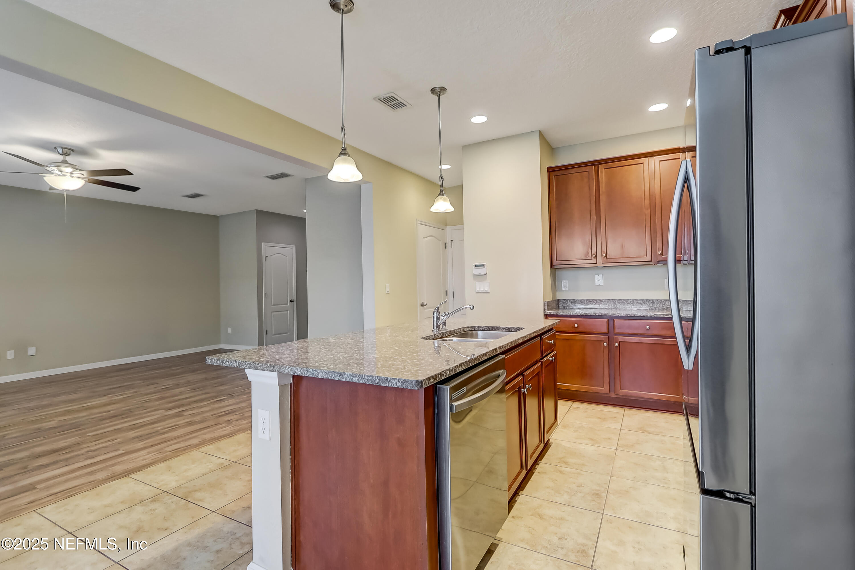 3838 Chasing Falls Road Orange Park, FL 32065 - Photo 10 of 36 a kitchen with stainless steel appliances granite countertop a sink and a refrigerator