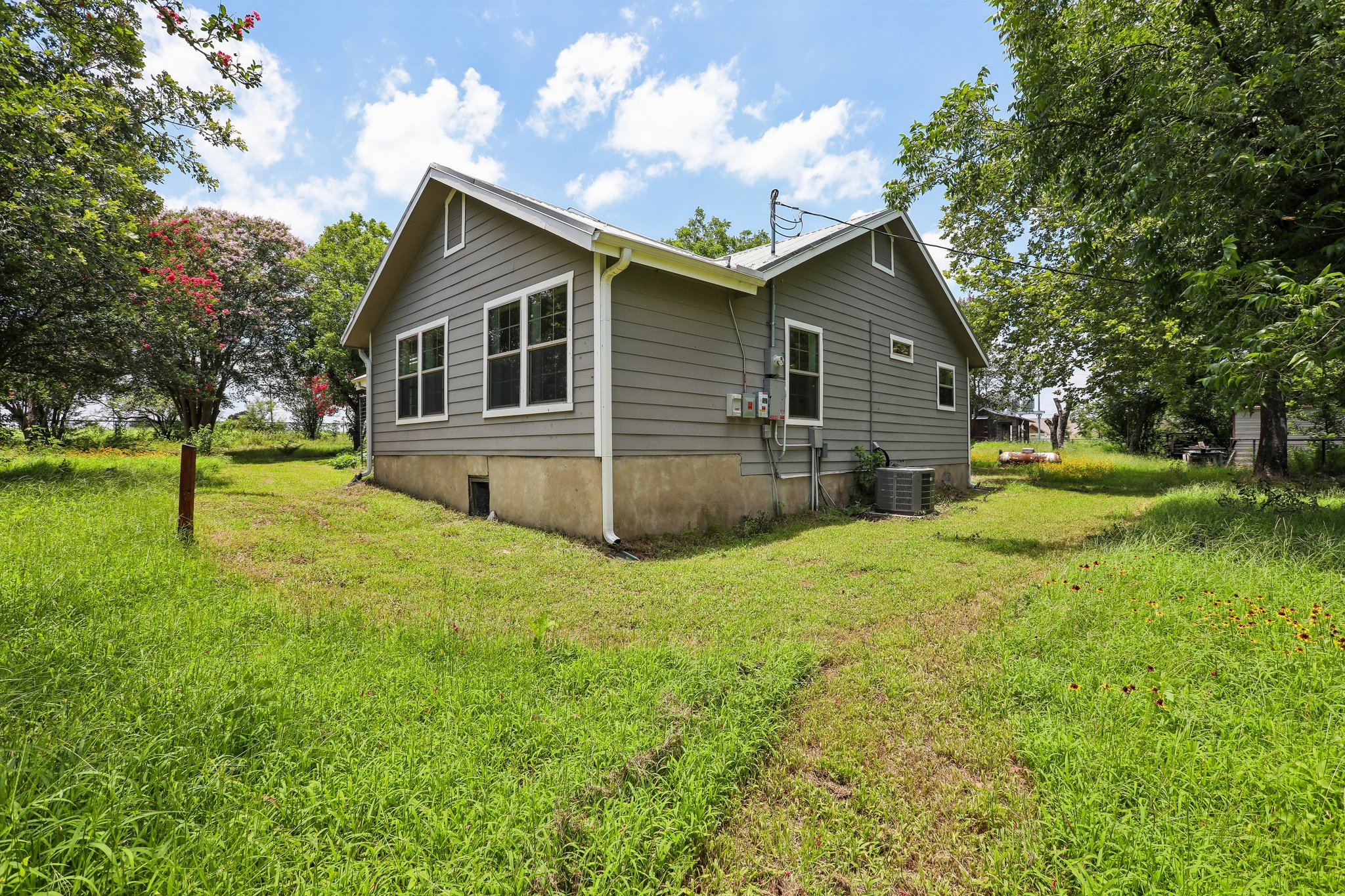 2089 Farm To Market Road 1704 Elgin, TX 78621 - Photo 23 of 31 A quaint residence with siding and a well-kept yard, offering ample outdoor space.