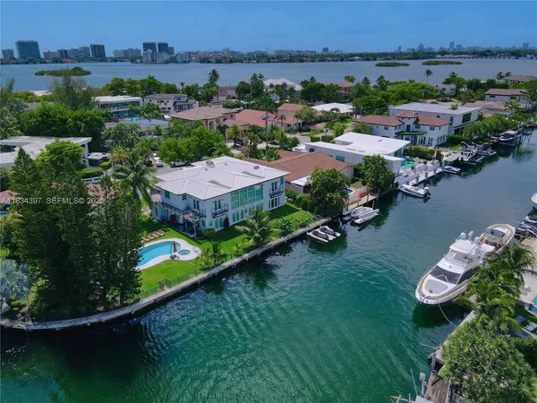 an aerial view of a house with a garden and lake view